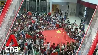 Hong Kong pro government protesters sing Chinese anthem in Kowloon mall