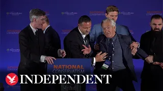 Protester removed from stage during Jacob Rees-Mogg National Conservatism conference speech