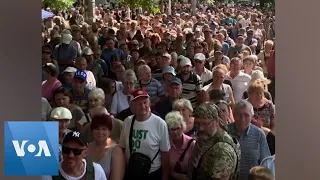 Ukrainians Queue for Water Before Curfew in Mykolaiv