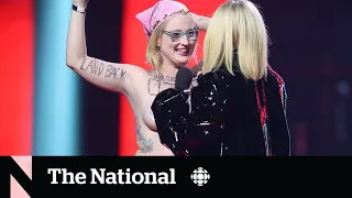 Avril Lavigne tells topless protester to get off stage