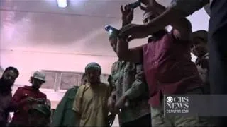 GRAPHIC VIDEO: Qaddafi's body on display in cooler