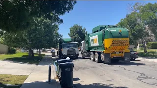 4 waste management garbage trucks in action.