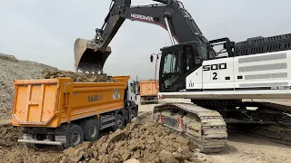 Hidromek Excavator loading two-way truck