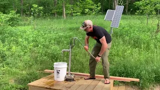 Off grid cabin bison hand pump well installation.