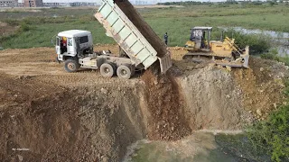 Wonderful Powerful Machine Bulldozer Dump Truck Spreading Dirt into Water on New Construction