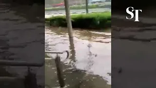 Flooded walkway outside King Albert Park MRT entrance on Bukit Timah Road on Aug 24, 2021