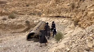 Jewish Ultra-Orthodox families inspect debris of what's believed to be an intercepted Iranian surfac