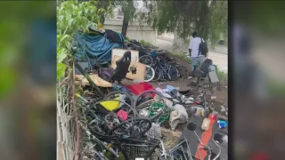 Dozens of bikes litter a freeway underpass. Neighbors want to know who will clean it up