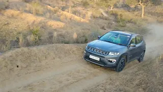 Off-roading with Jeep compass in sand-desert.