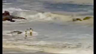 Clifton lifeguards rescue stand from Cape Towns massive swell. From live stream webcam