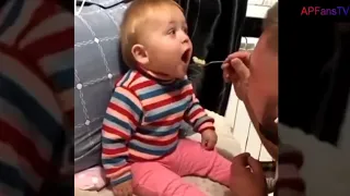 Toddler giggling as father attempted to feed him