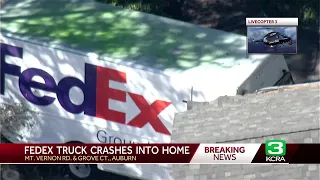 FedEx truck crashes into Auburn home, police say