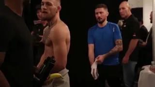 Conor McGregor stares down Tyron Woodley back stage at UFC 205