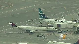 Two Planes Touch Wings At LaGuardia Airport