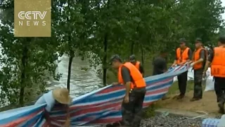 China floods: Government helps locals cope with effects of torrential rain