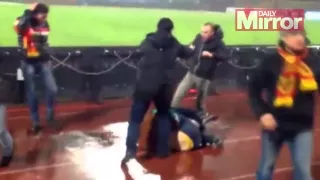 Violent clashes between rival football fans caught on camera before ref is forced to halt match