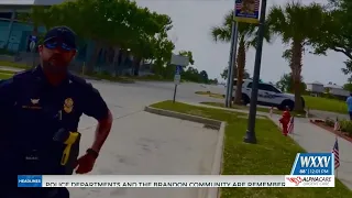 Waveland officer exchange with man in front of City Hall