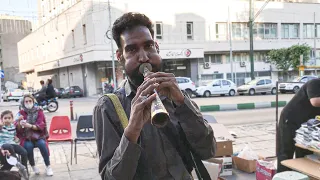 playing ancient wind instrument called sorna or bugle