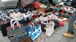 Street vendors on Canal Street selling imitation designer bags in all kinds of weather.