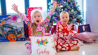 Gaby and Alex opening presents on Christmas morning 2020