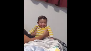 Adorable five month old baby laughing hysterically at Dad's antics. Funny