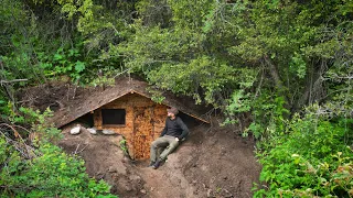 I'm building a shelter in the woods, a cozy survival hut made of wood.